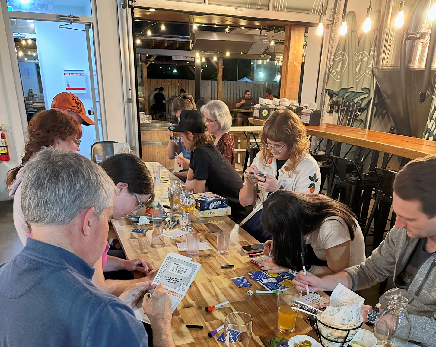Members playing a board game together at a Bored to Board game night in Langley
